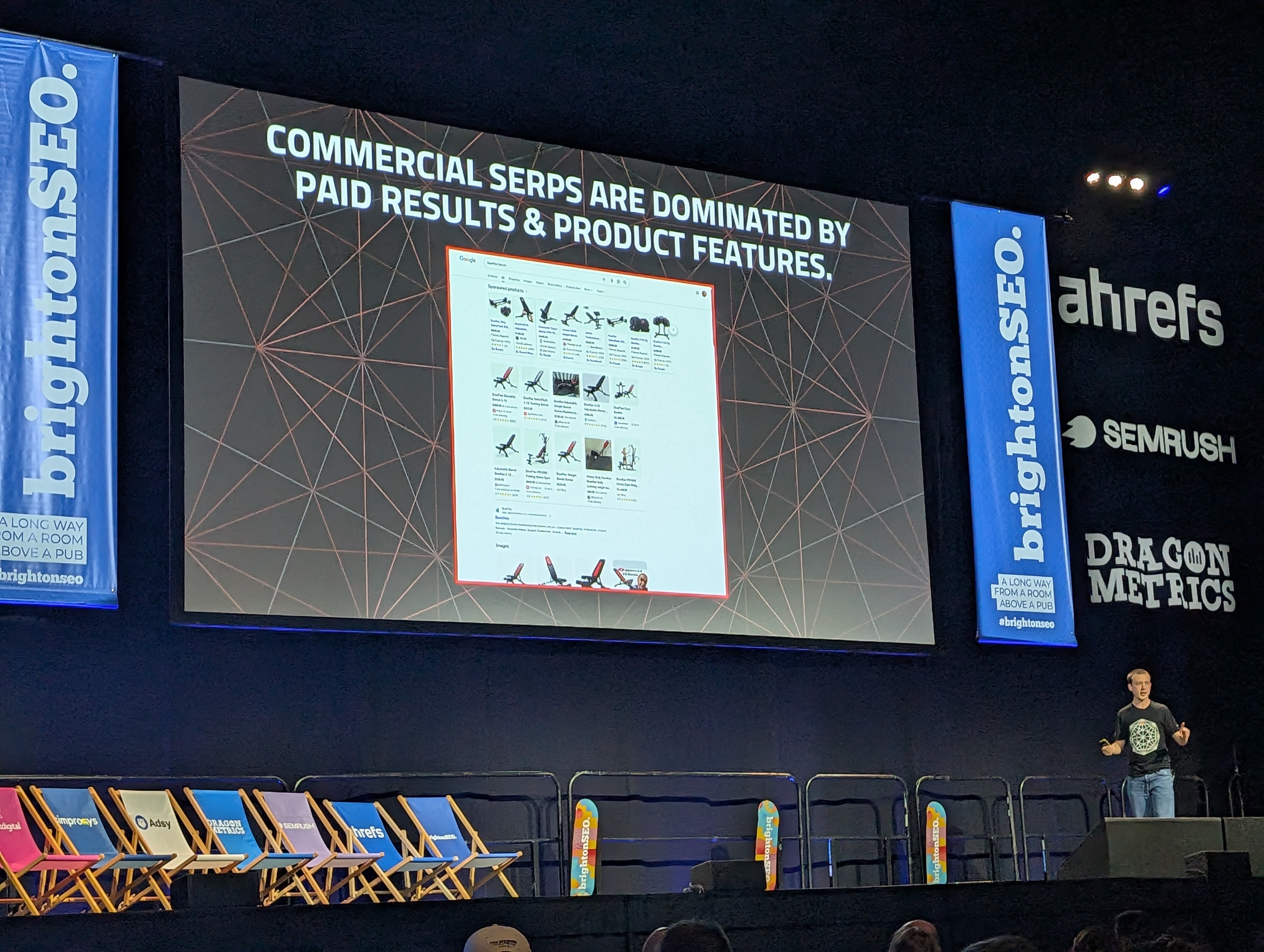 Tom Capper's slide at brightonSEO April 2026 showing how paid results dominate commercial SERPs before organic listings appear